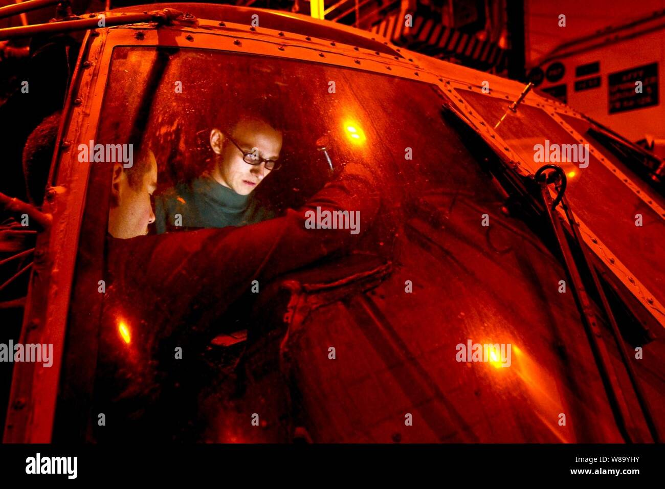 U.S. Navy Airman Joseph Clemson troubleshoots electronics on an SH-60F Seahawk helicopter aboard the aircraft carrier USS Carl Vinson (CVN 70) in the Pacific Ocean on Dec. 3, 2010.  The Carl Vinson is on a three-week composite training unit exercise followed by a deployment to the western Pacific Ocean.  Clemson, an aviation electronics technician, is assigned to Helicopter Anti-Submarine Squadron 15. Stock Photo