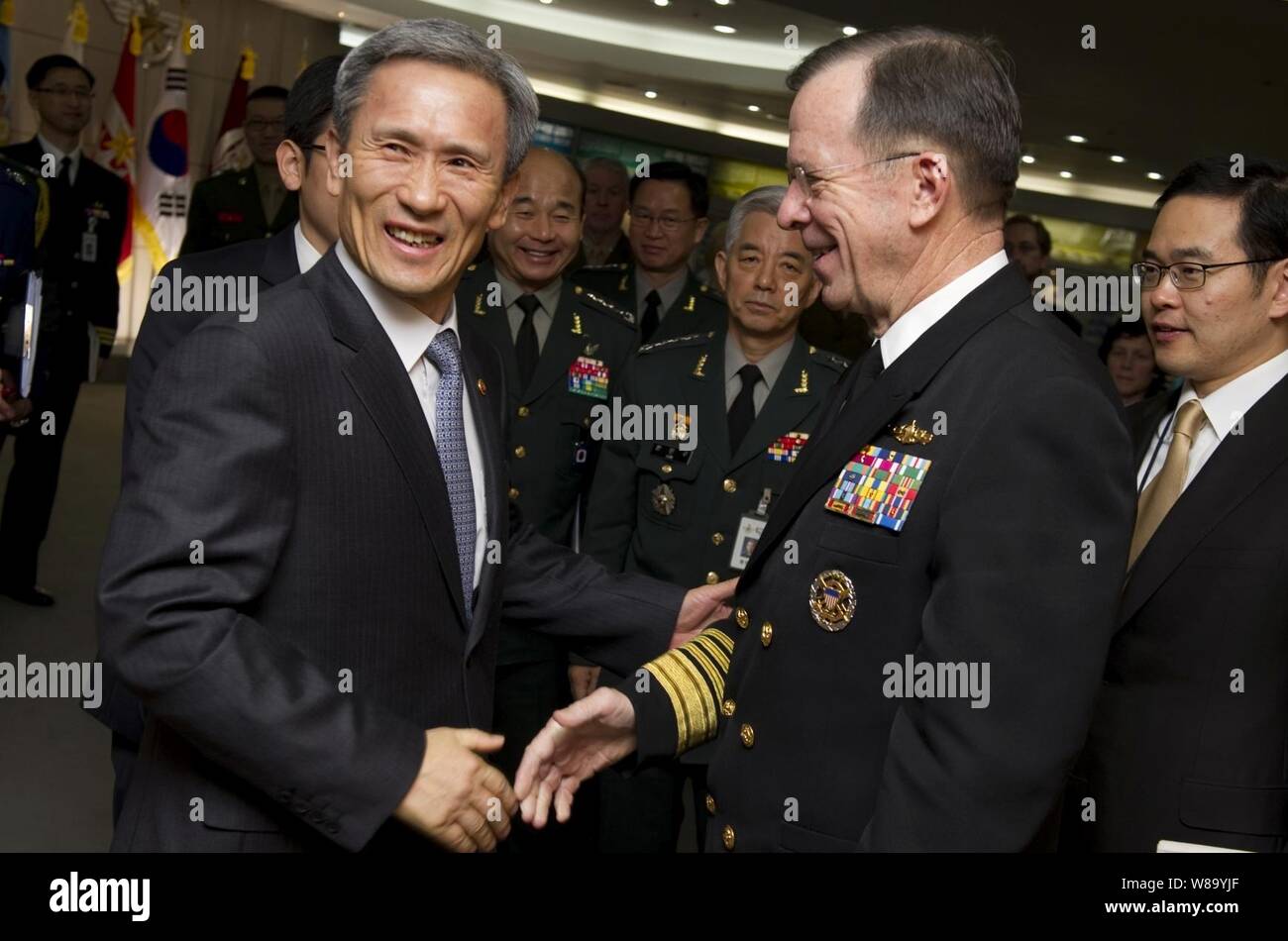 Chairman of the Joint Chiefs of Staff Adm. Mike Mullen, U.S. Navy, is greeted by South Korean Minister of Defense Kim Kwan-jin during meetings in Seoul, Republic of South Korea, on Dec. 8, 2010.  Mullen traveled to Korea to meet with defense officials there reassuring the strength of the U.S.-South Korean alliance in light of recent tensions with the north. Stock Photo