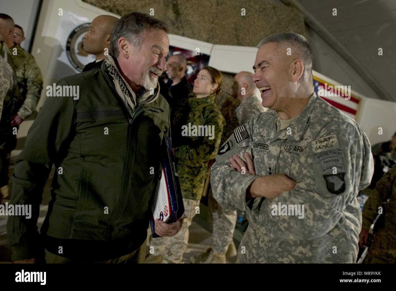 Comedian Robin Williams visits with Commanding General of Combined Task Force 101 U.S. Army Lt. Gen. John F. Campbell after the USO Holiday Tour show at Bagram Air Field, Afghanistan, on Dec.15, 2010.  Chairman of the Joint Chiefs of Staff Adm. Mike Mullen, U.S. Navy, and his wife Deborah are hosting the holiday tour featuring Williams and comedians Lewis Black and Kathleen Madigan, Tour de France champion Lance Armstrong and country musicians Kix Brooks and Bob Dipiero touring the Central Command area of responsibility. Stock Photo