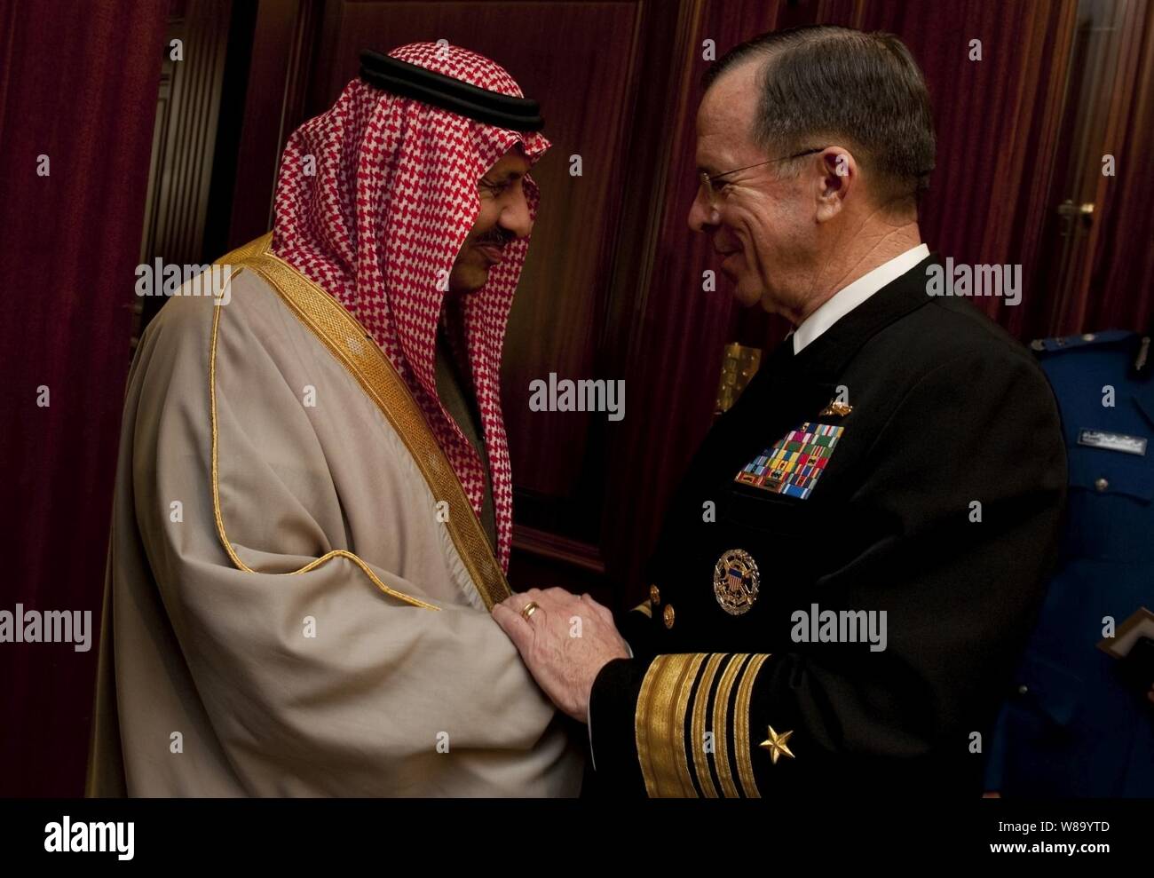 Chairman of the Joint Chiefs of Staff Adm. Mike Mullen, U.S. Navy, greets Saudi Arabian Assistant Minister of Defense and Aviation Prince Khalid bin Sultan in Riyadh on Feb. 21, 2011.  Mullen is on a weeklong trip through the Middle East to reassure friends and allies of the U.S. commitment to regional stability. Stock Photo
