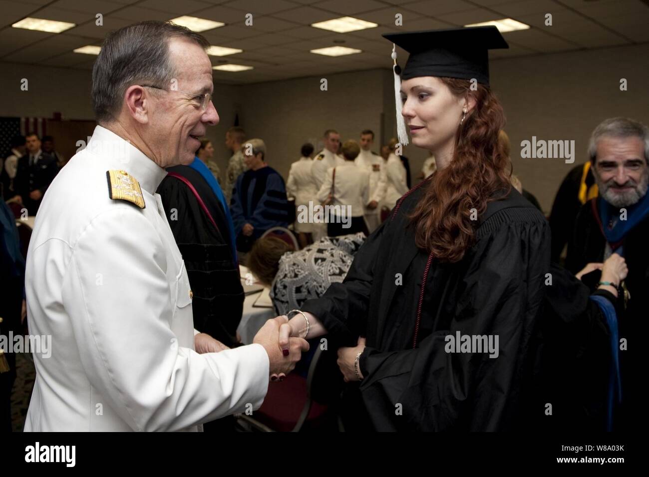 Chairman of the Joint Chiefs of Staff Adm. Mike Mullen, U.S. Navy, greets U.S. Army Staff Sgt. Shasha Maria-Martin prior to Florida State University 2011 Spring Commencement ceremonies in Tallahassee, Fla., on April 30, 2011.  Martin, a twice-deployed Iraq veteran, graduated with a degree in International Relations. Stock Photo