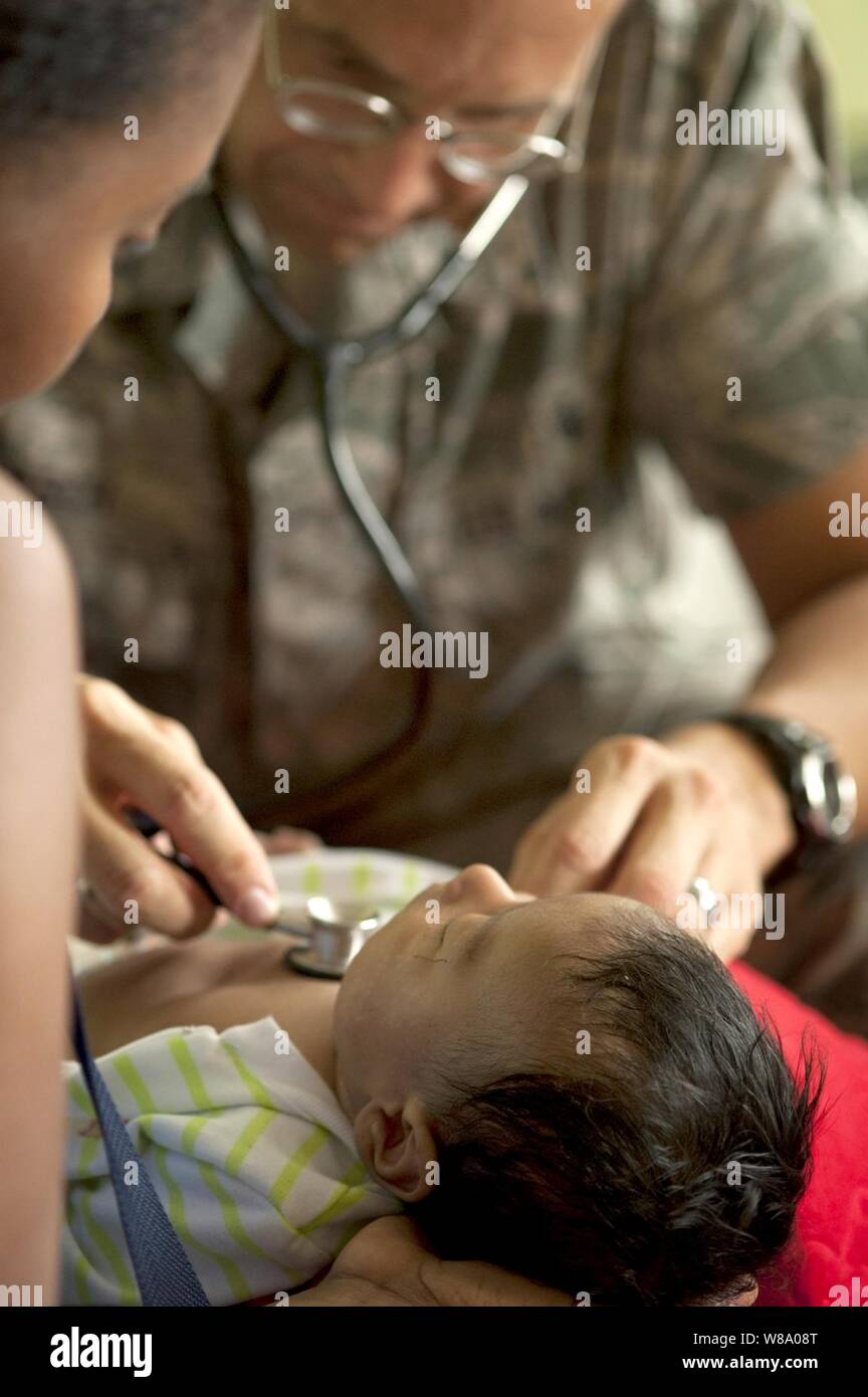 U.S. Air Force Maj. Gary Ruesch examines a young patient at the Escuela Max Seidel medical site during Continuing Promise 2011 in Tumaco, Colombia, on June 7, 2011.  Ruesch is a nurse practitioner. Stock Photo