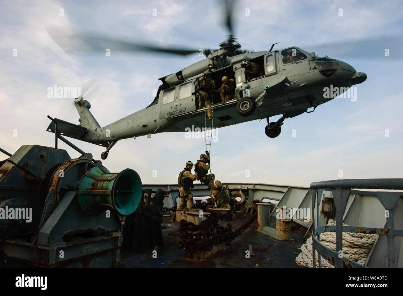 A U.S. Navy MH-60S Seahawk helicopter attached to Helicopter Sea Combat Squadron 28 conducts a shipboard extraction from an Italian Navy training vessel in the Gulf of La Spezia on March 13, 2012. Stock Photo
