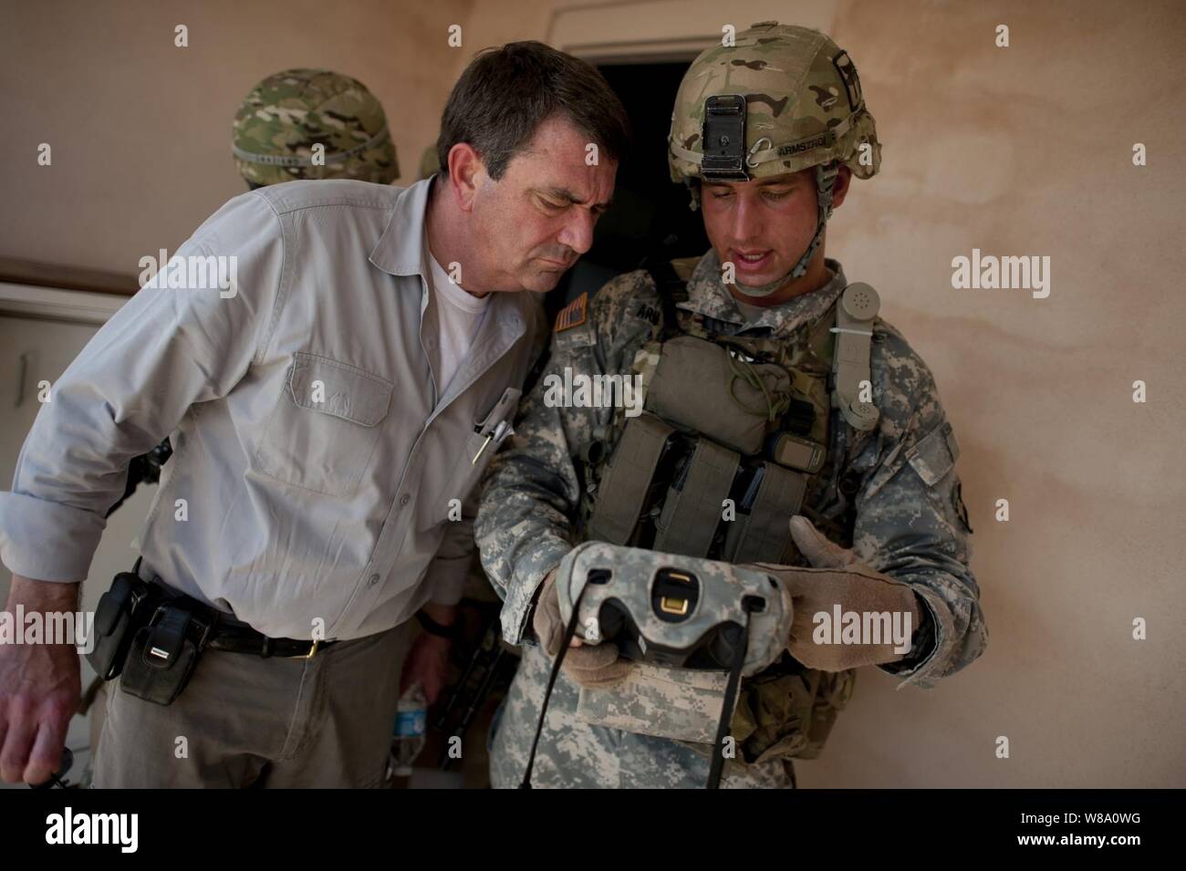 U.S. Army Sgt. Donald Armstrong explains a biometric scanning system to Deputy Secretary of Defense Ashton M. Carter during a counter Improvised Explosive Device training exercise, on Fort Campbell, Ky., on June 20, 2012.  Armstrong is assigned to the 101st Airborne Division. Stock Photo