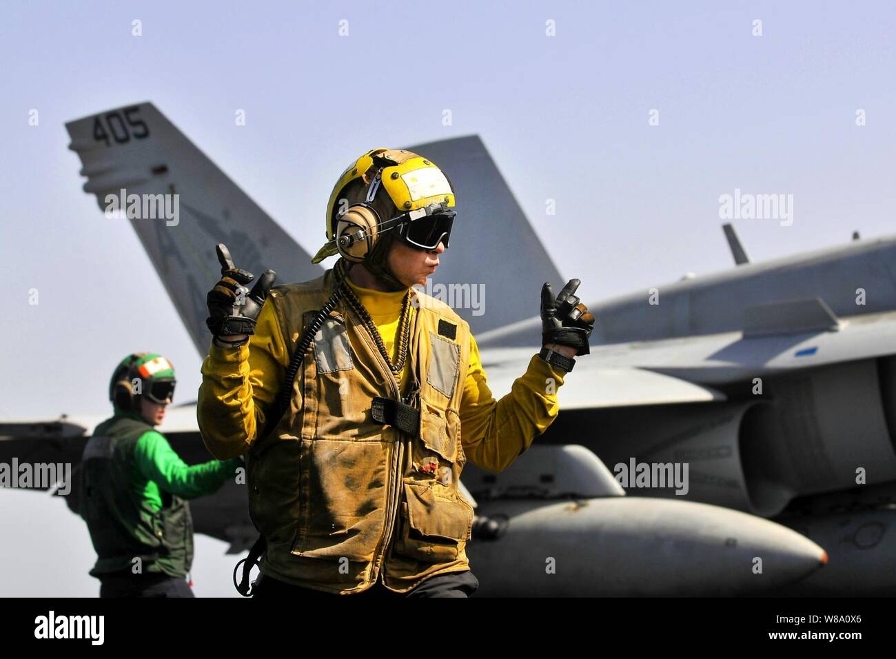 ARABIAN SEA (March 15, 2012) Aviation BoatswainÕs Mate (Handling) Airman Cody Ottmo, assigned to the Air DepartmentÕs V-1 Division, directs an F/A-18C Hornet on the flight deck aboard the Nimitz-class aircraft carrier USS Carl Vinson (CVN 70). Carl Vinson and Carrier Air Wing (CVW) 17 are deployed to the U.S. 5th Fleet area of responsibility. (U.S. Navy Stock Photo