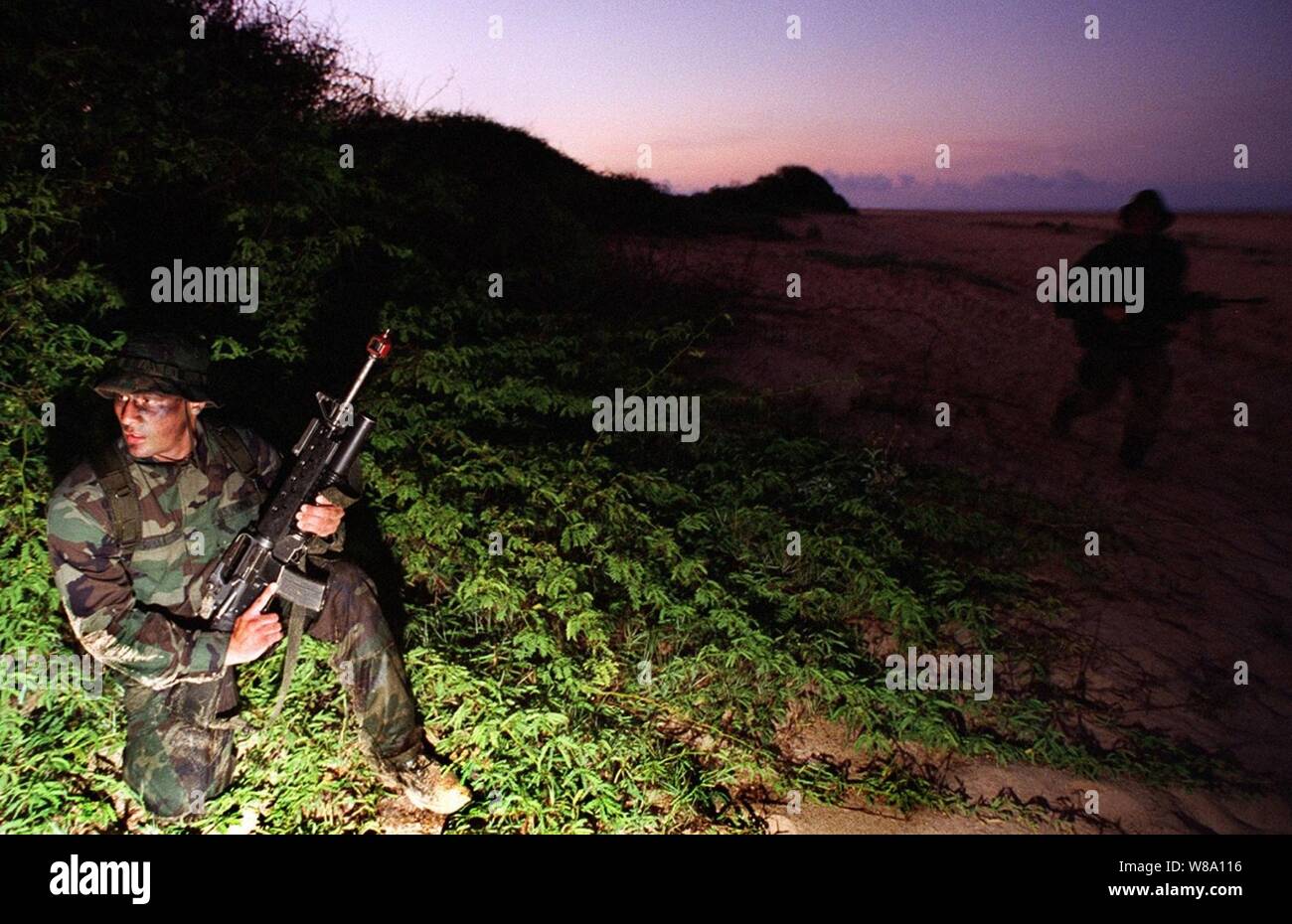 U.S. Marines conduct an early morning boat raid as a pre-emptive strike against enemy forces before a large amphibious assault on June 15, 1996, as part of RIMPAC Ф96.  The amphibious assault at Pacific Missile Range Facility, Barking Sands, Hawaii, is being conducted by 11th Marine Expeditionary Unit, Camp Pendleton, Calif., and involves Navy and Marine air, ground and sea forces for training as a combined amphibious assault force.  More than 44 ships, 200 aircraft and 30,000 soldiers, sailors, Marines, airmen and Coast Guardsmen are involved in the exercise.  The purpose of RIMPAC Ф96 is to Stock Photo