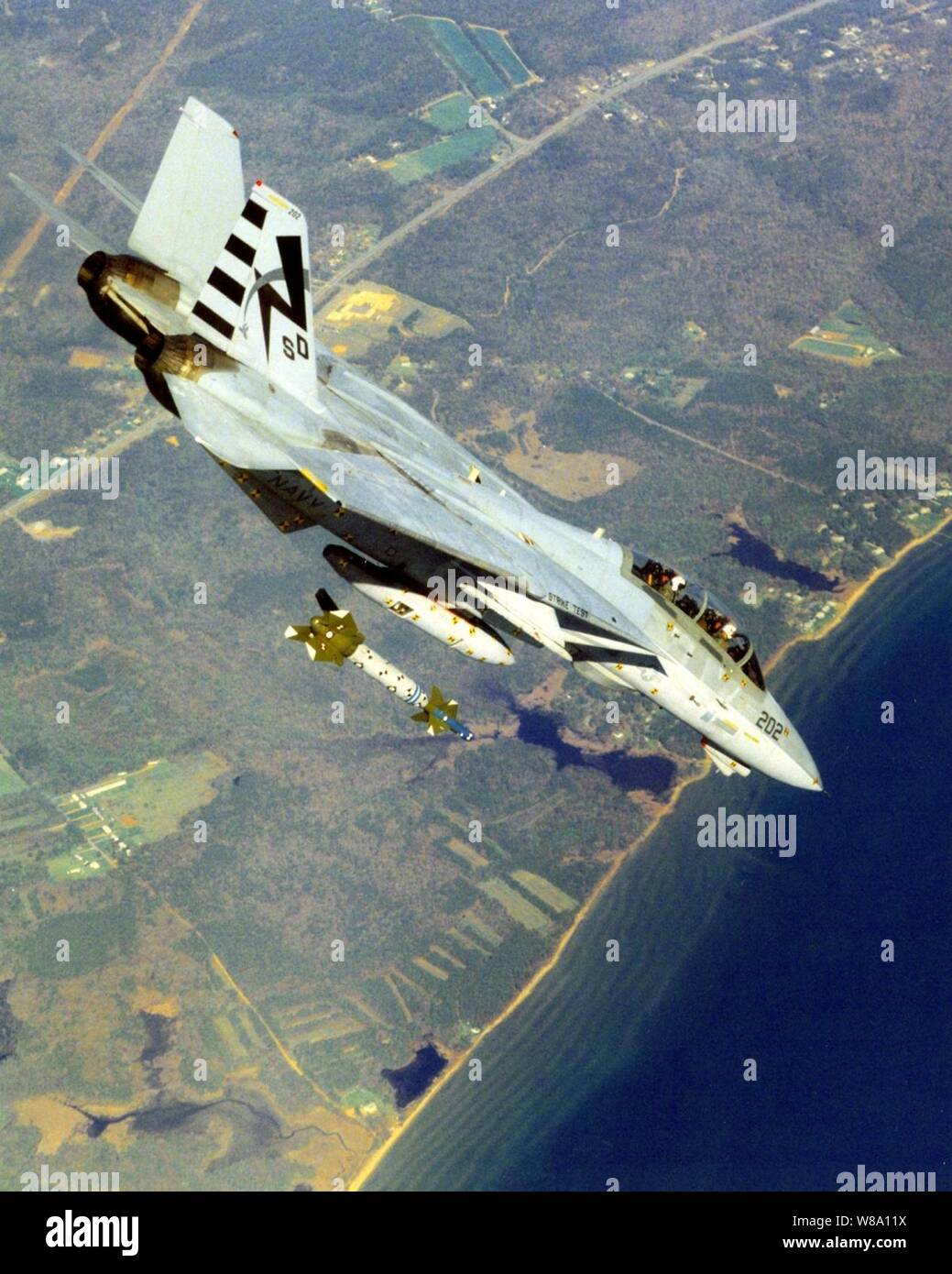A U.S. Navy F-14A Tomcat releases a GBU-24B/B Hard Target Penetrator Laser-Guided Bomb while in a in a 45-degree dive during ordnance separation testing on May 10, 1996.  The Navy is conducting the tests at Naval Air Station Patuxent River, Md., as part of an air-to-ground development program to support clearance for use of the weapon in the fleet  by F-14 Tomcats.  This Tomcat is assigned to the Strike Aircraft Test Squadron at Patuxent River. Stock Photo