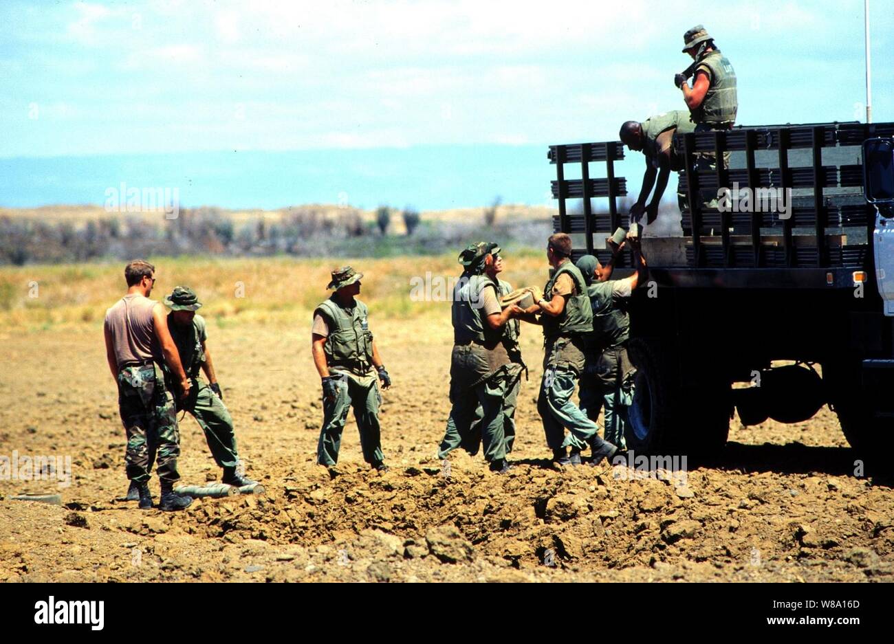 Marine Barracks Minefield Maintenance personnel unload deactivated anti-tank and anti-personnel land mines for destruction at a demolition site on Naval Station Guantanamo Bay, Cuba, in this March 18, 1997, file photo.  Anti-personnel and anti-tank land mines on the U.S. side of the fence separating Communist Cuba and the U.S. Naval Base at Guantanamo Bay are being removed in accordance with the Presidential Order of May 16, 1996.  Approximately 50,000 land mines were placed in the buffer zone between Communist Cuba and Guantanamo Bay beginning in 1961 as a result of the Cold War. The land min Stock Photo