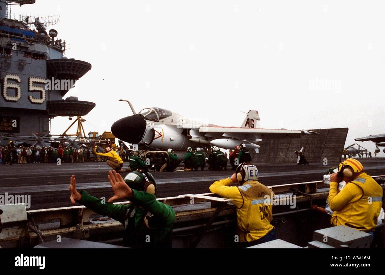 A U.S. Navy A-6E Intruder receives the signal to launch from catapult three of the aircraft carrier USS Enterprise (CVN 65), on Dec. 19, 1996, marking the last Intruder squadron to fly from the deck of an aircraft carrier.  The Intruder, from Attack Squadron 75, Naval Air Station Oceana, Va., sports the AG tail code and paint scheme representing Carrier Air Wing 7, the squadronХs first air wing over 30 years ago.  The squadron, known as the Sunday Punchers, will be decommissioned in early 1997. Stock Photo