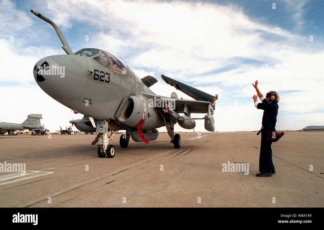 Airman Wallace Holden directs the pilot of this U.S. Navy EA-6B Prowler to the parking ramp area at Roswell, N.M. on April 18, 1997, during exercise Roving Sands 97.  More than 20,000 service members from all branches of the armed forces of the U.S., Canada, Germany, and the Netherlands are participating in Exercise Roving Sands 97.  The exercise is designed to refine their skills in operations using an integrated air defense network of ground, missile and radar early warning systems combined with tactical fighter and bomber aircraft operating in a simulated high-threat environment.  Holden is Stock Photo