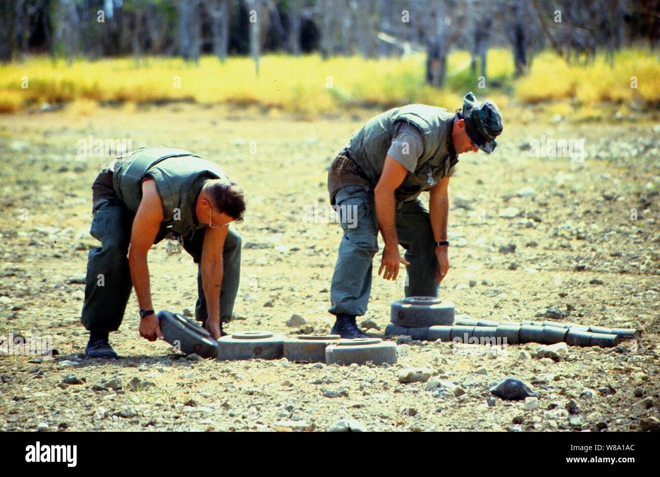 Marine Barracks Minefield Maintenance personnel stack deactivated anti-tank and anti-personnel land mines for destruction at a demolition site on Naval Station Guantanamo Bay, Cuba, in this July 10, 1997, file photo.  Anti-personnel and anti-tank land mines on the U.S. side of the fence separating Communist Cuba and the U.S. Naval Base at Guantanamo Bay are being removed in accordance with the Presidential Order of May 16, 1996.  Approximately 50,000 land mines were placed in the buffer zone between Communist Cuba and Guantanamo Bay beginning in 1961 as a result of the Cold War. The land mines Stock Photo