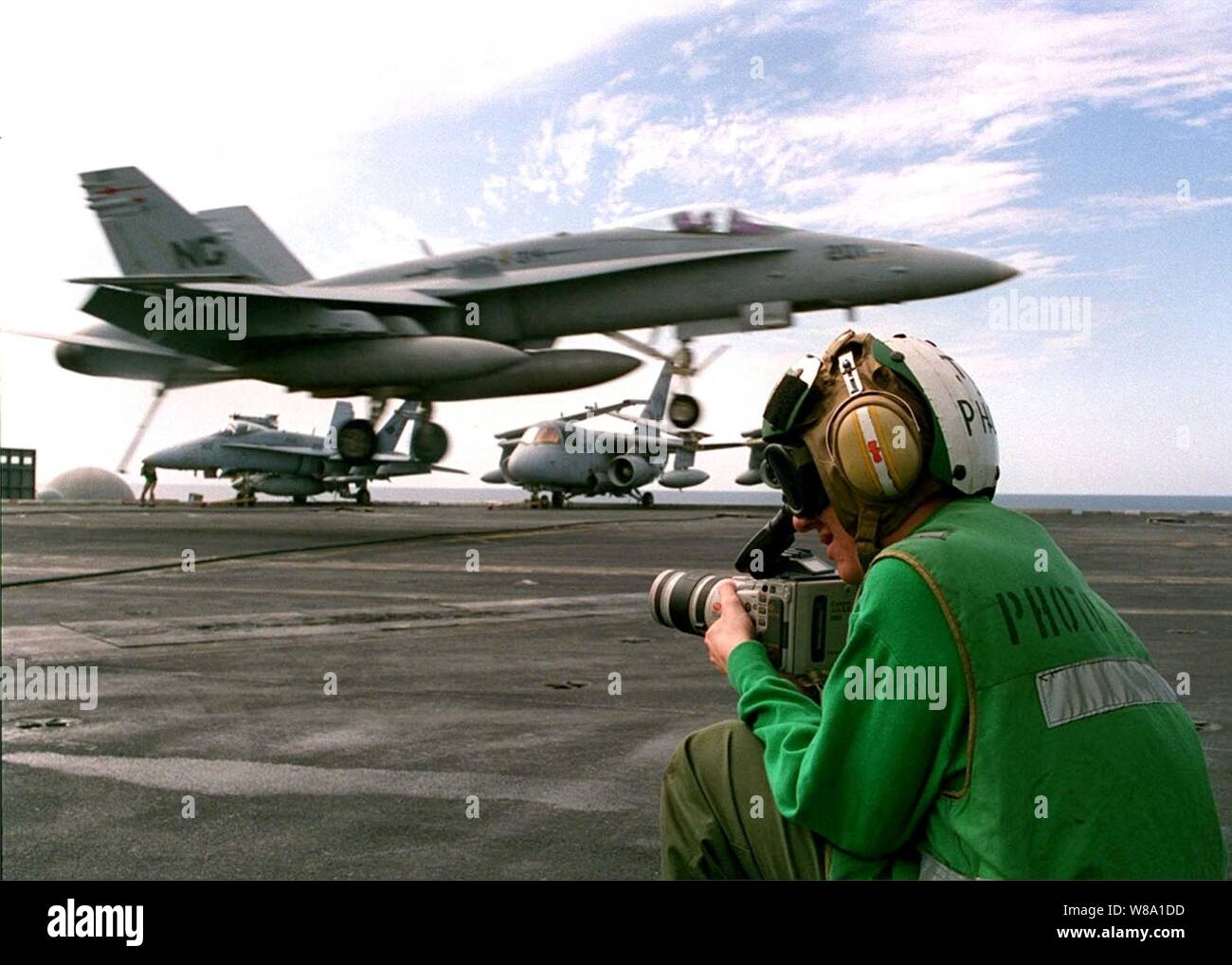 U.S. Navy Photographer's Mate Airman Benjamin Story uses a Hi-8 video camera to document daily flight operations on the flight deck of the aircraft carrier USS Nimitz (CVN 68) in the Persian Gulf on Nov. 6, 1997.  The Nimitz and embarked Carrier Air Wing 9 are operating in the Persian Gulf in support of the U.S. and coalition enforcement of the no-fly-zone over Southern Iraq.  Story, from Pomfret, Md., is assigned to the Operations Department, Photographic Division. Stock Photo