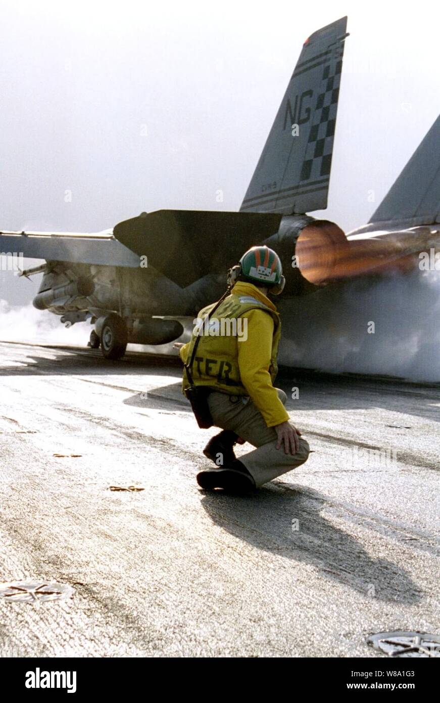 U.S. Navy Lt. Rick Krystof watches an F-14 Tomcat hurtle down the catapult of the aircraft carrier USS Nimitz (CVN 68) on Jan. 29, 1998.  The Nimitz battle group is operating in the Persian Gulf in support of Operation Southern Watch which is the U.S. and coalition enforcement of the no-fly-zone over Southern Iraq.  Krystof  is from Westford, Mass. Stock Photo