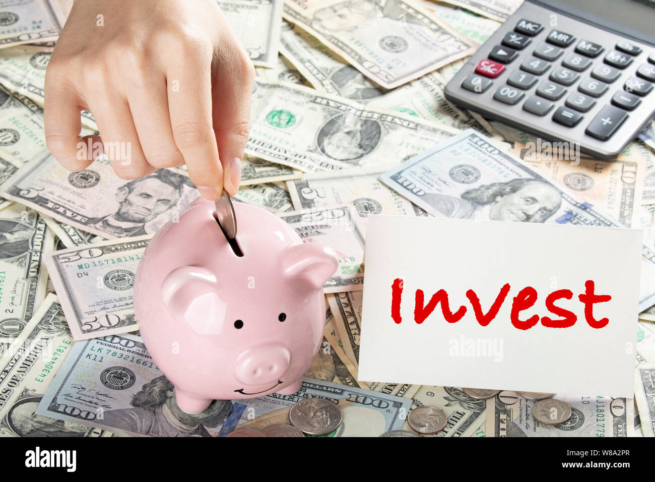 United States bank notes and coins with a calcultor, piggy bank, and