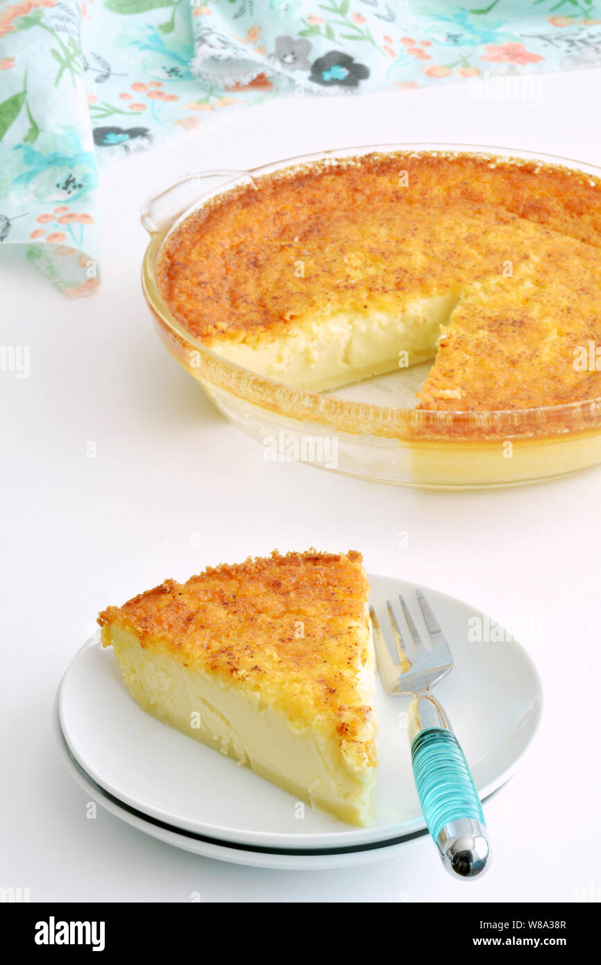 All the deliciousness of egg custard pie slice without the heavy pastry.  Gluten free, homemade comfort food in vertical format. Stock Photo