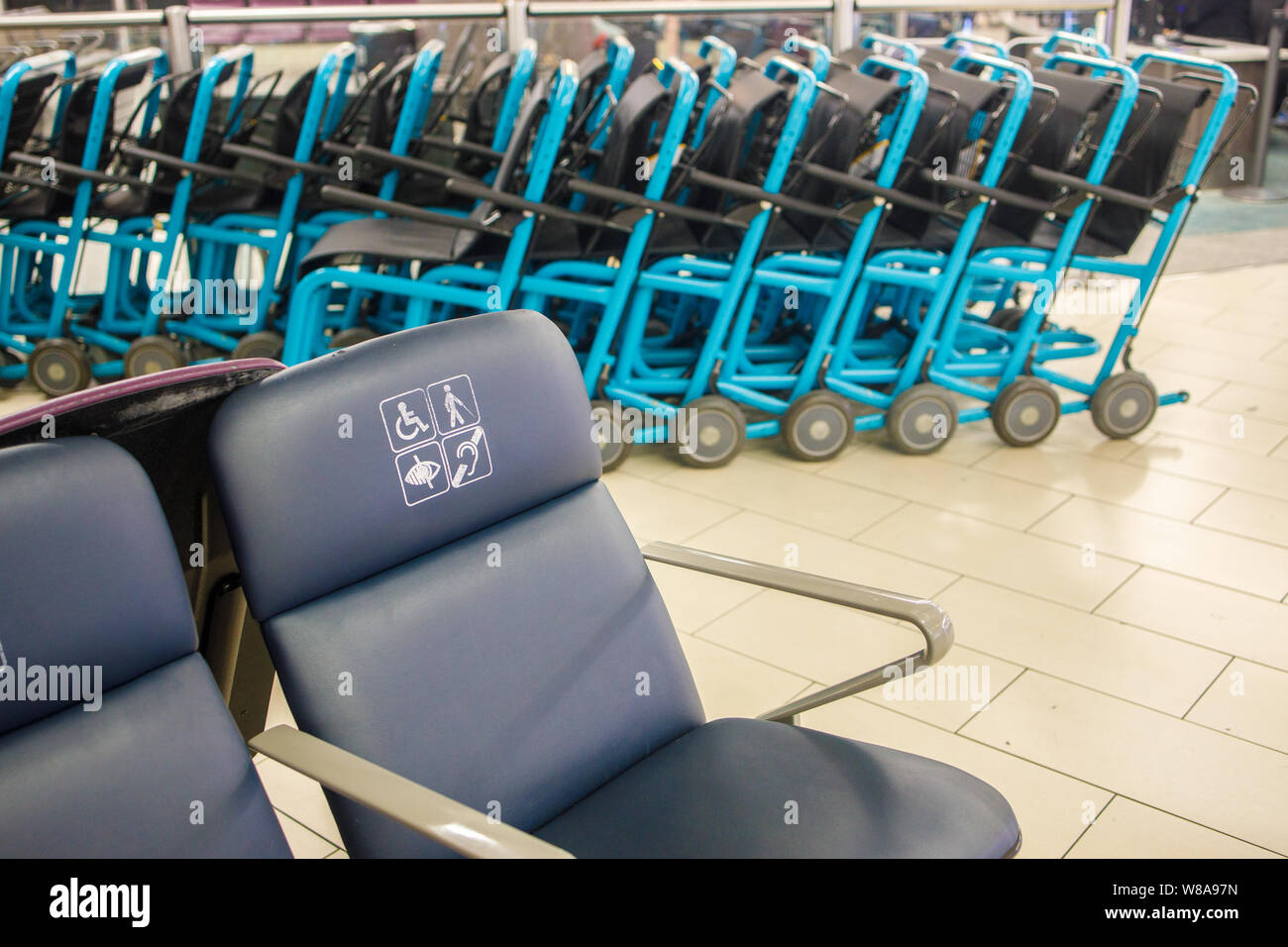 Disabled chairs and row of wheelchairs at an airport Stock Photo Alamy