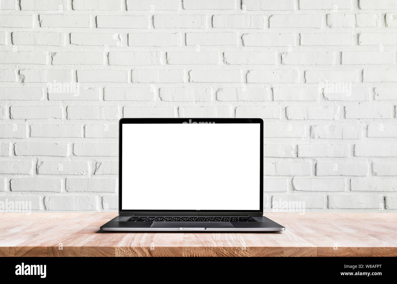 Modern computer,laptop with blank screen on white wall brick backgrounds Stock Photo