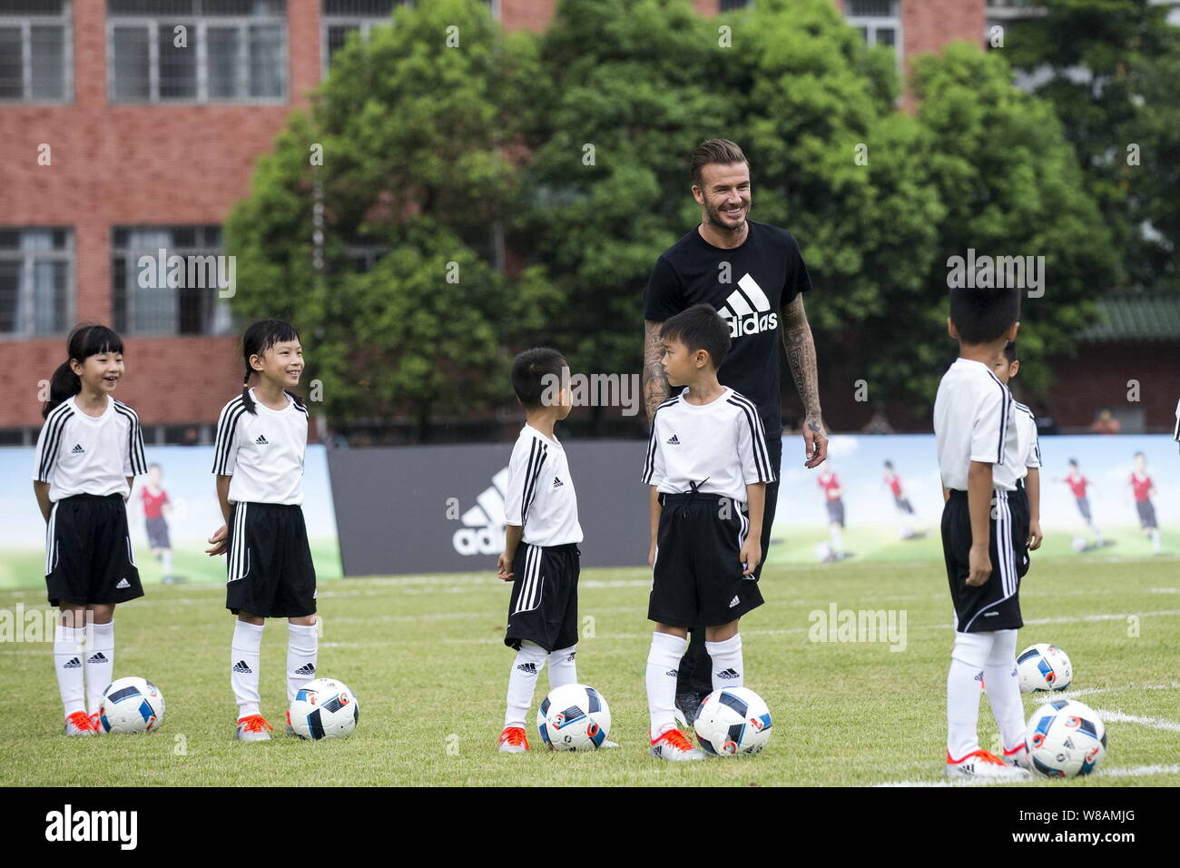 English football star David Beckham instructs young Chinese kids to play  football during a football campaign by Adidas at Zhixin High School in  Guangz Stock Photo - Alamy