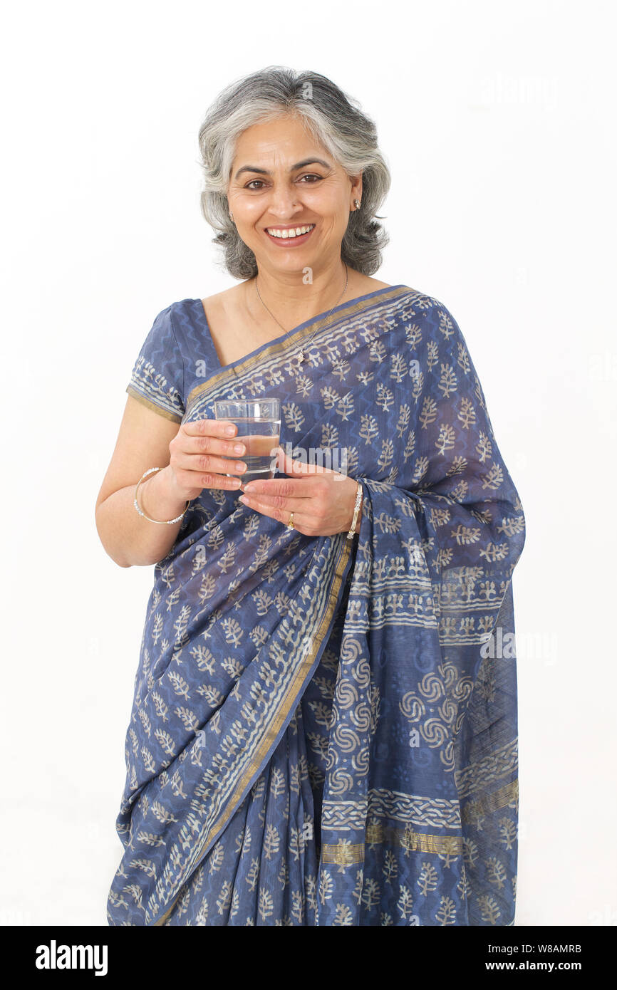 Senior woman holding a glass of water Stock Photo