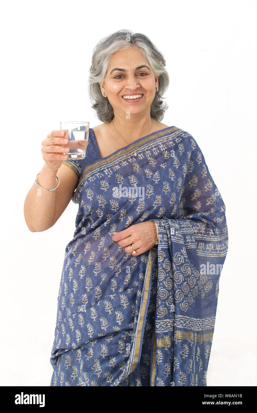 Senior woman holding a glass of water Stock Photo
