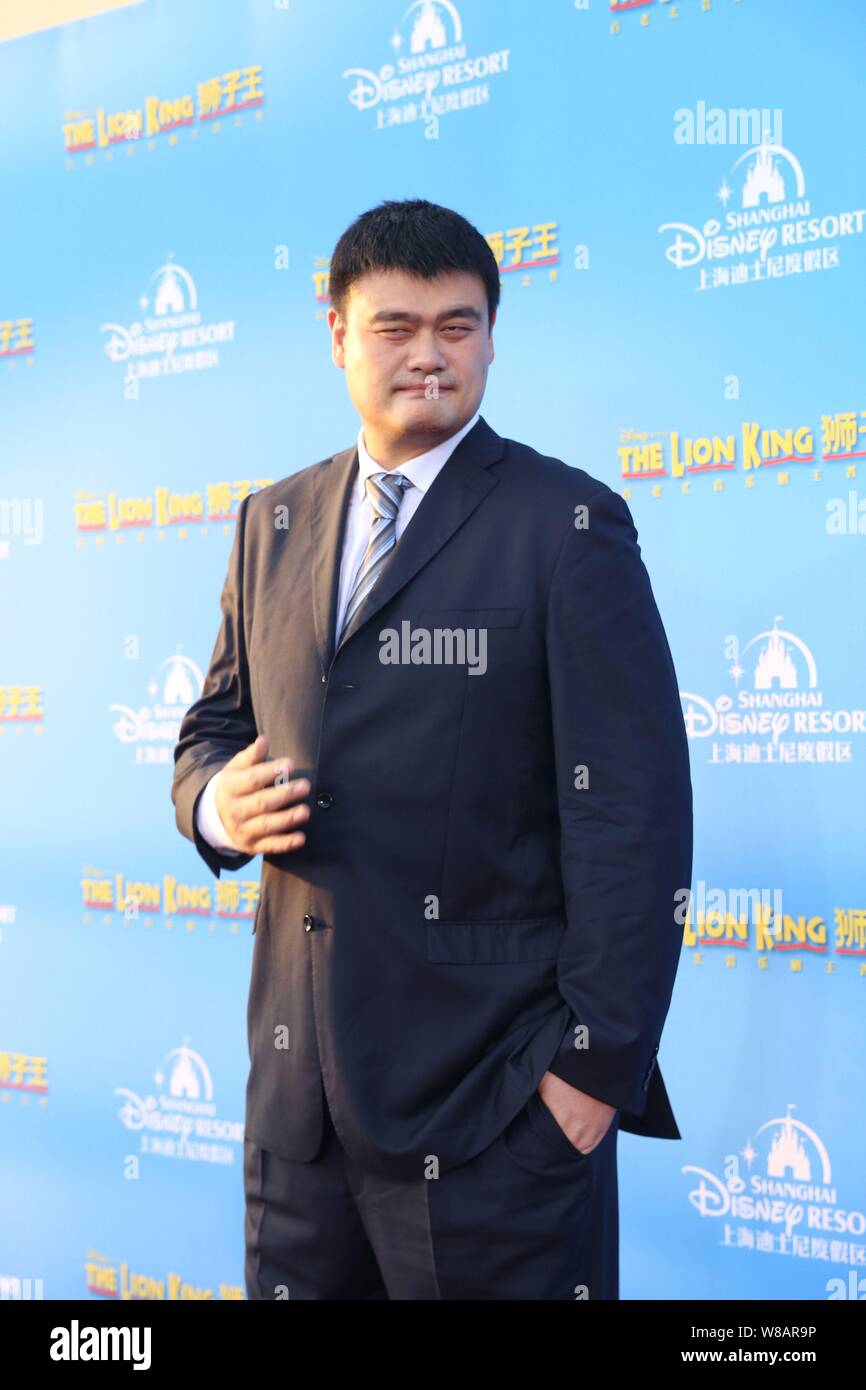 Retired Chinese basketball star Yao Ming poses at the world premiere for the Chinese version of the music drama 'The Lion King' at the Shanghai Disney Stock Photo
