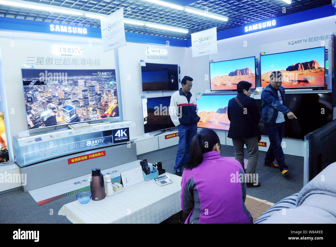 --FILE--Chinese customers shop for LCD TV sets of Samsung at a home appliance store in Qingdao city, east China's Shandong province, 30 October 2015. Stock Photo