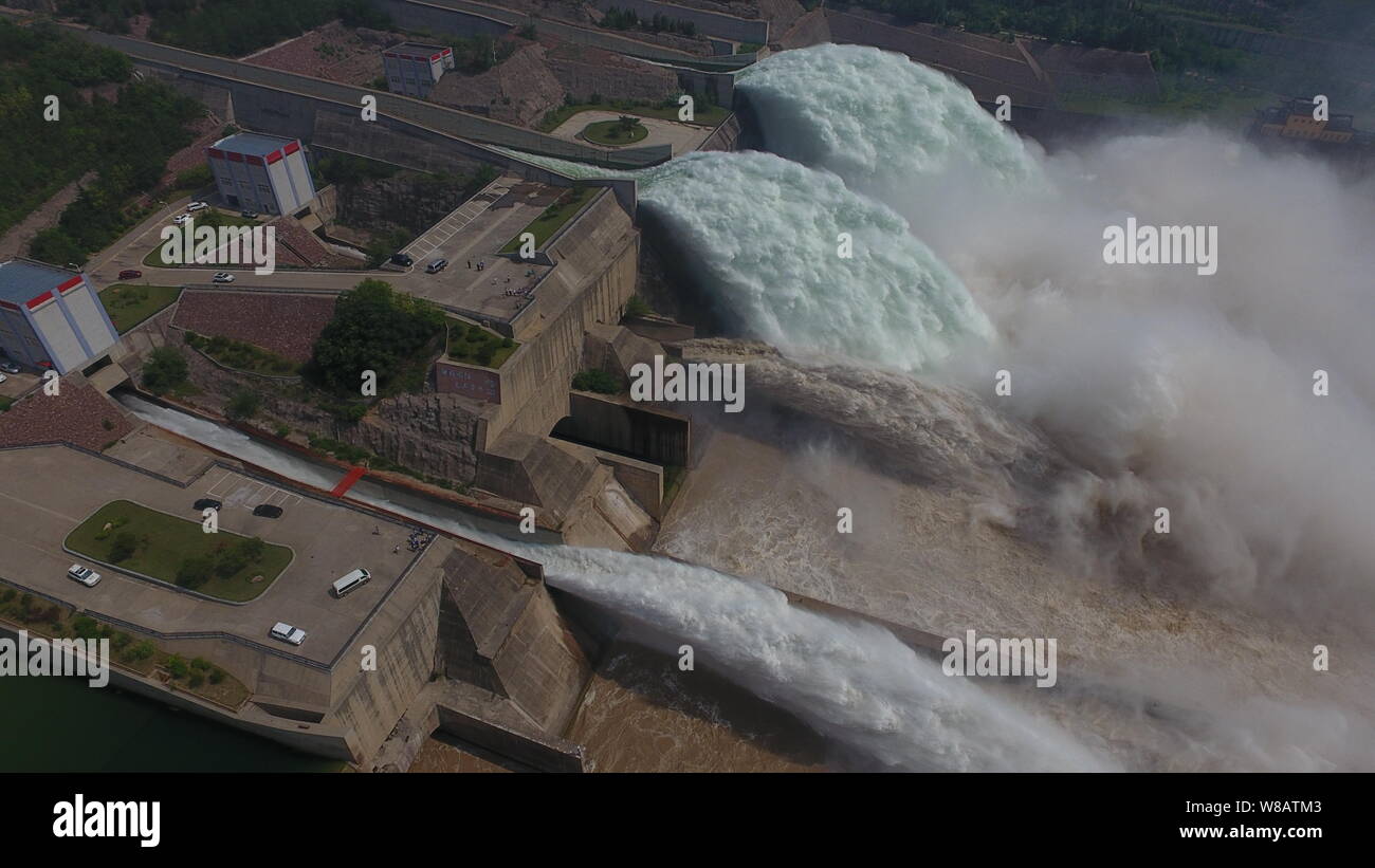 Silt-laden water rushing over a weir on the River Stour Blandford Dorset  England UK Stock Photo - Alamy