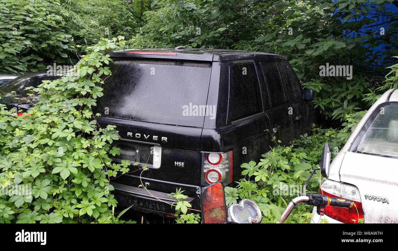 A Land Rover SUV and a Toyota car are parking in an impound lot after ...