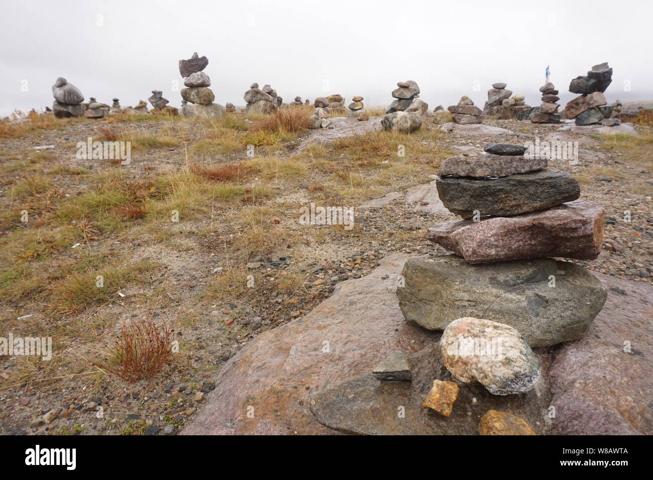Stones are stakced on a tundra field in Teriberka, Russia. Stock Photo