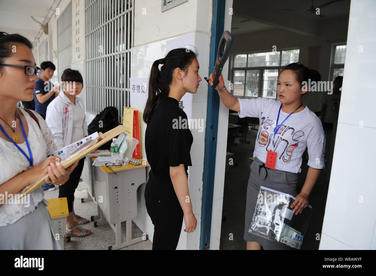 Chinese students queue up to receive security checks before entering