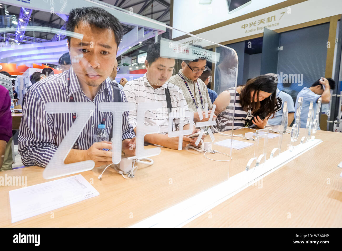 Visitors try out ZTE smartphones during the 2016 Mobile World Congress (MWC) in Shanghai, China, 29 June 2016.   Given the capacity and performance bo Stock Photo