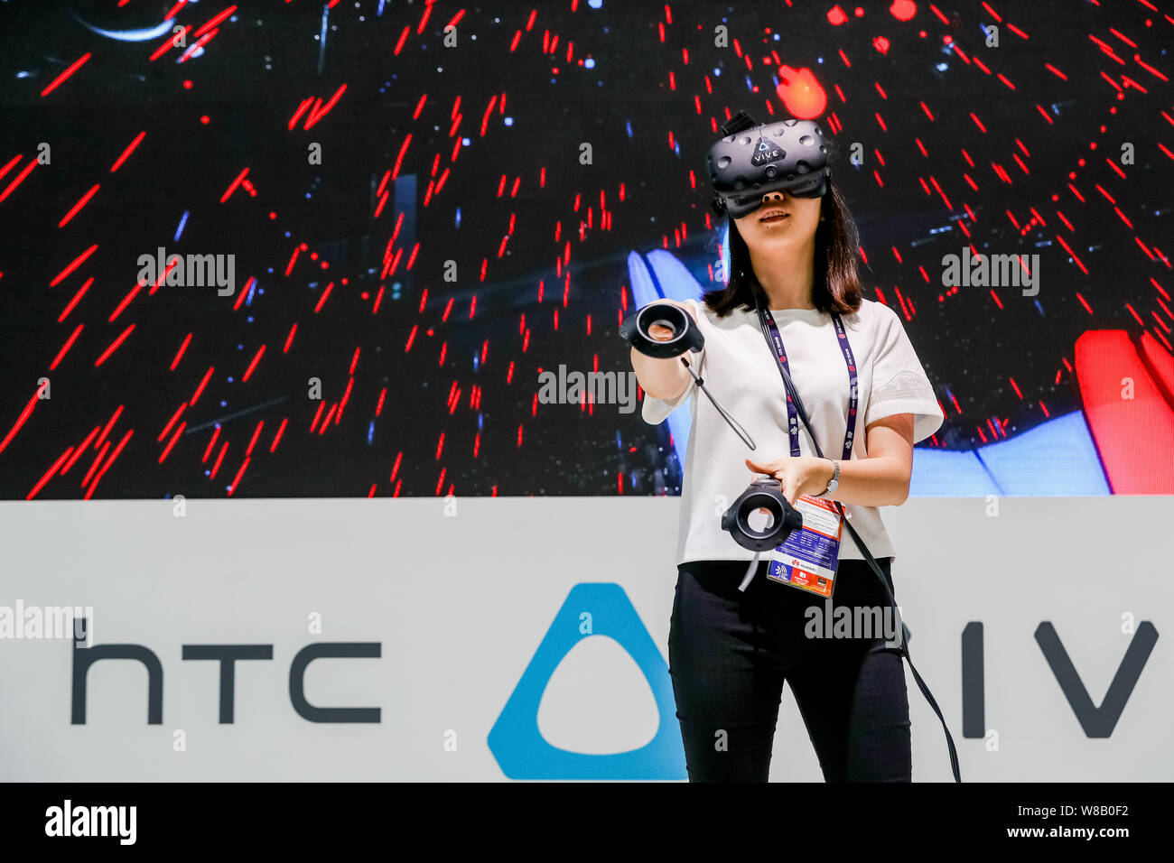 A visitor tries out a HTC VR (Virtual Reality) device during the 2016 Mobile World Congress (MWC) in Shanghai, China, 29 June 2016.   The Mobile World Stock Photo