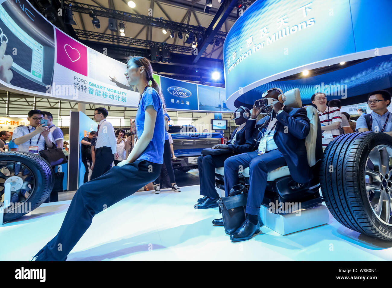 Visitors try out VR (Virtual Reality) devices of Ford Smart Mobility during the 2016 Mobile World Congress (MWC) in Shanghai, China, 29 June 2016.   T Stock Photo