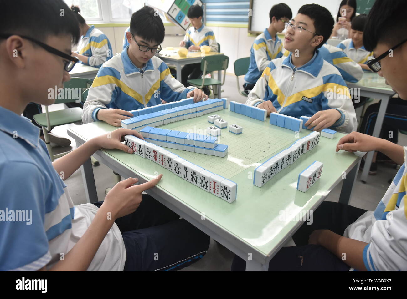 Young Chinese student play "English Mahjong" to learn English in the