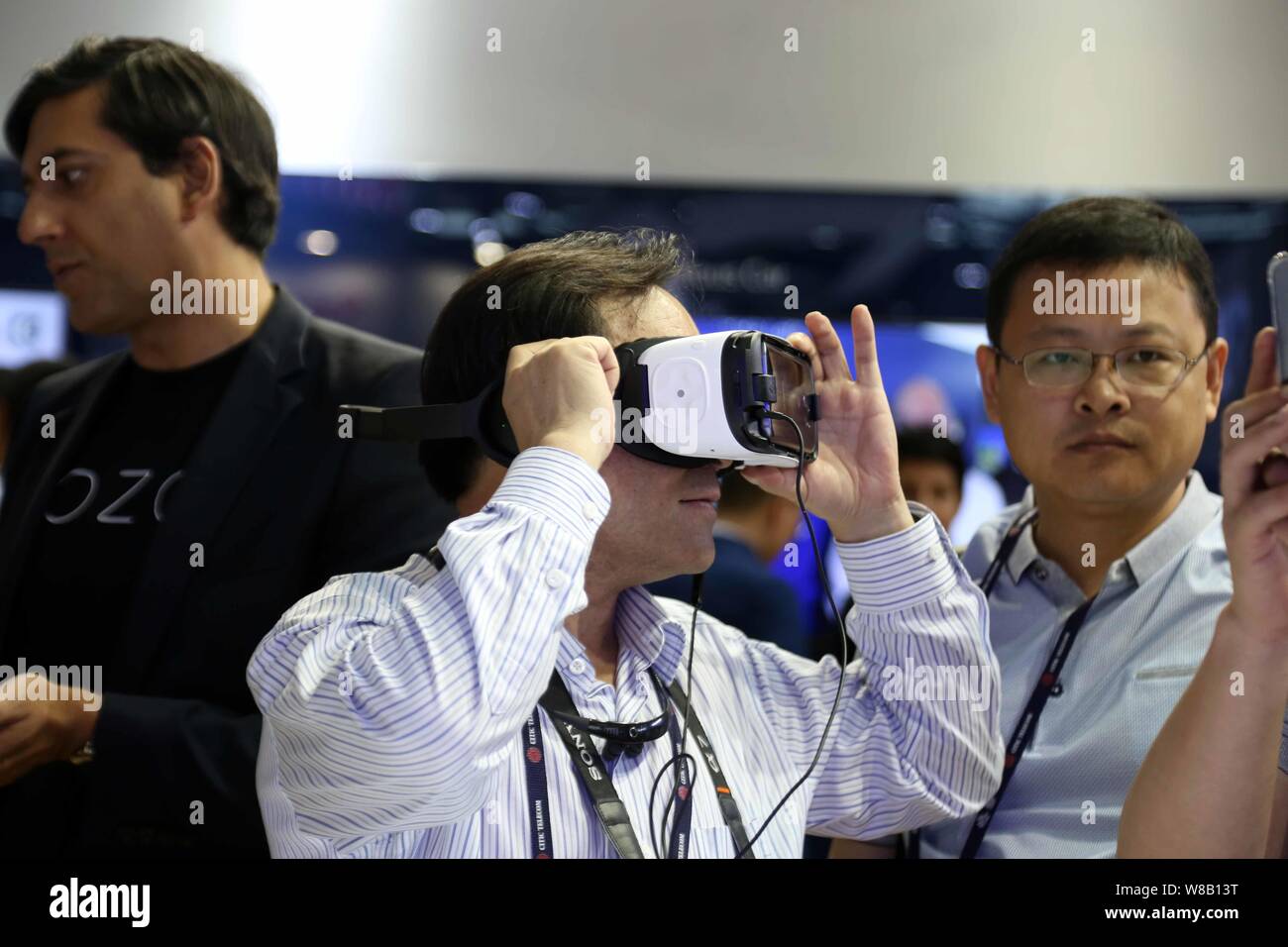 A visitor tries out an HTC VR (Virtual Reality) device during the 2016 Mobile World Congress (MWC) in Shanghai, China, 29 June 2016.   The Mobile Worl Stock Photo