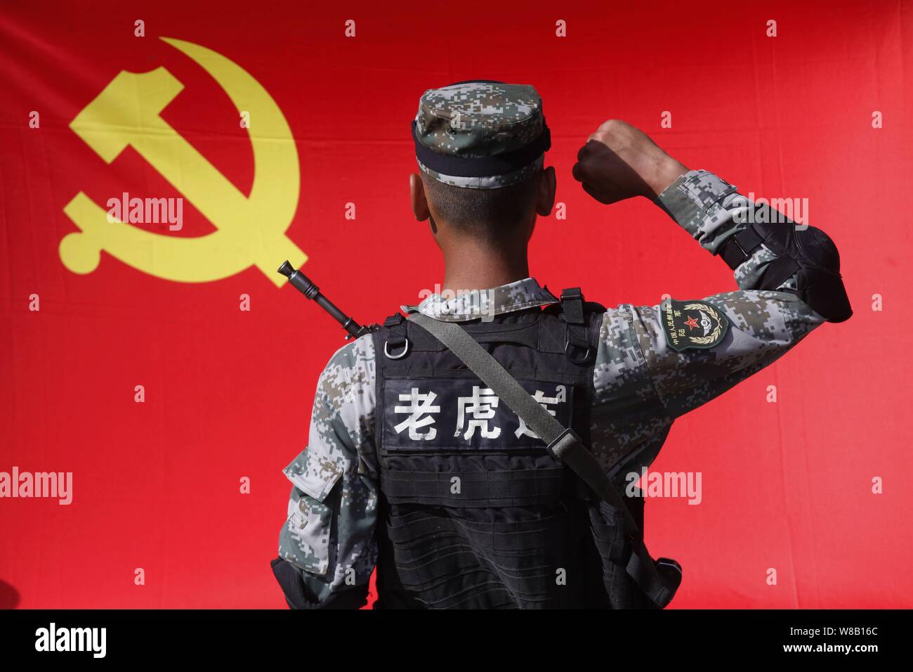 A Chinese PLA (People's Libration Army) soldier swears in in front of a ...
