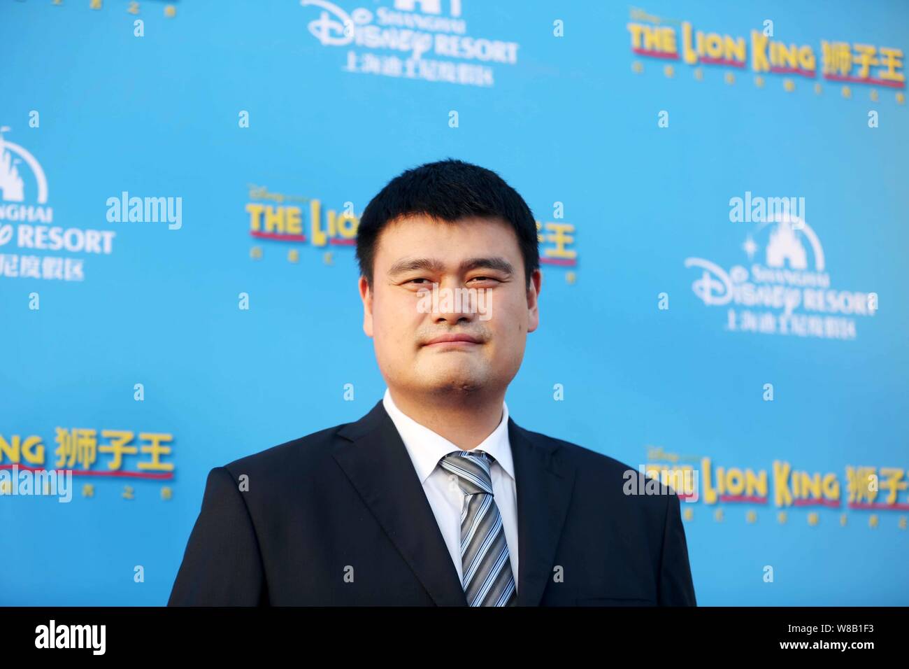 Retired Chinese basketball star Yao Ming poses at the world premiere for the Chinese version of the music drama 'The Lion King' at the Shanghai Disney Stock Photo