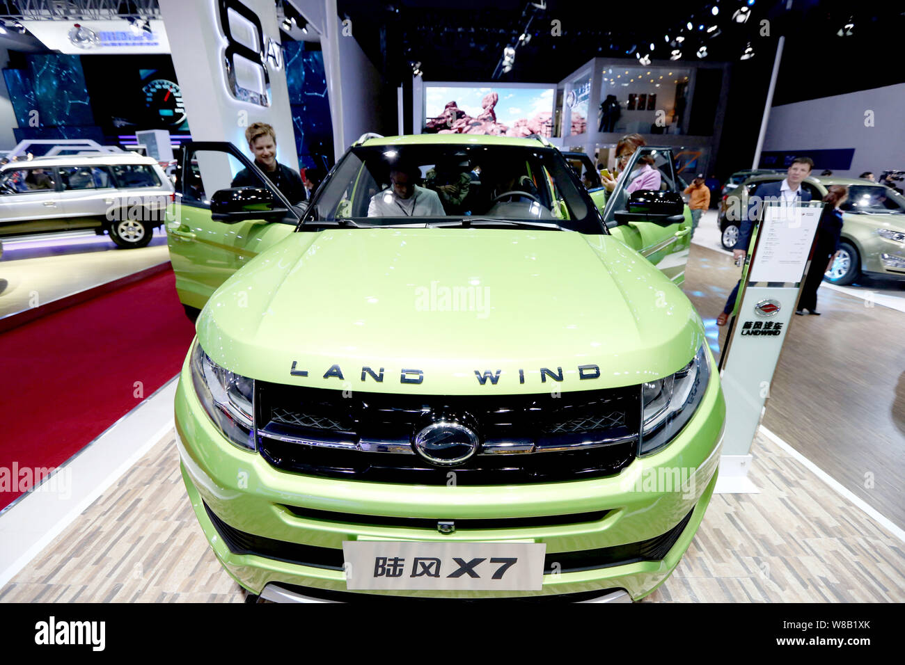 --FILE--Visitors try out or look at a Landwind X7 SUV of JMC (Jiangling Motor Co.), which resembles the Range Rover Evoque of Jaguar Land Rover, durin Stock Photo