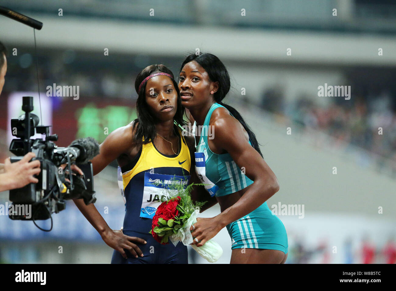 Shaunae Miller of Bahamas, right, poses with Shericka Jackson of Jamaica after winning the women's 400m during the IAAF Diamond League Shanghai 2016 i Stock Photo