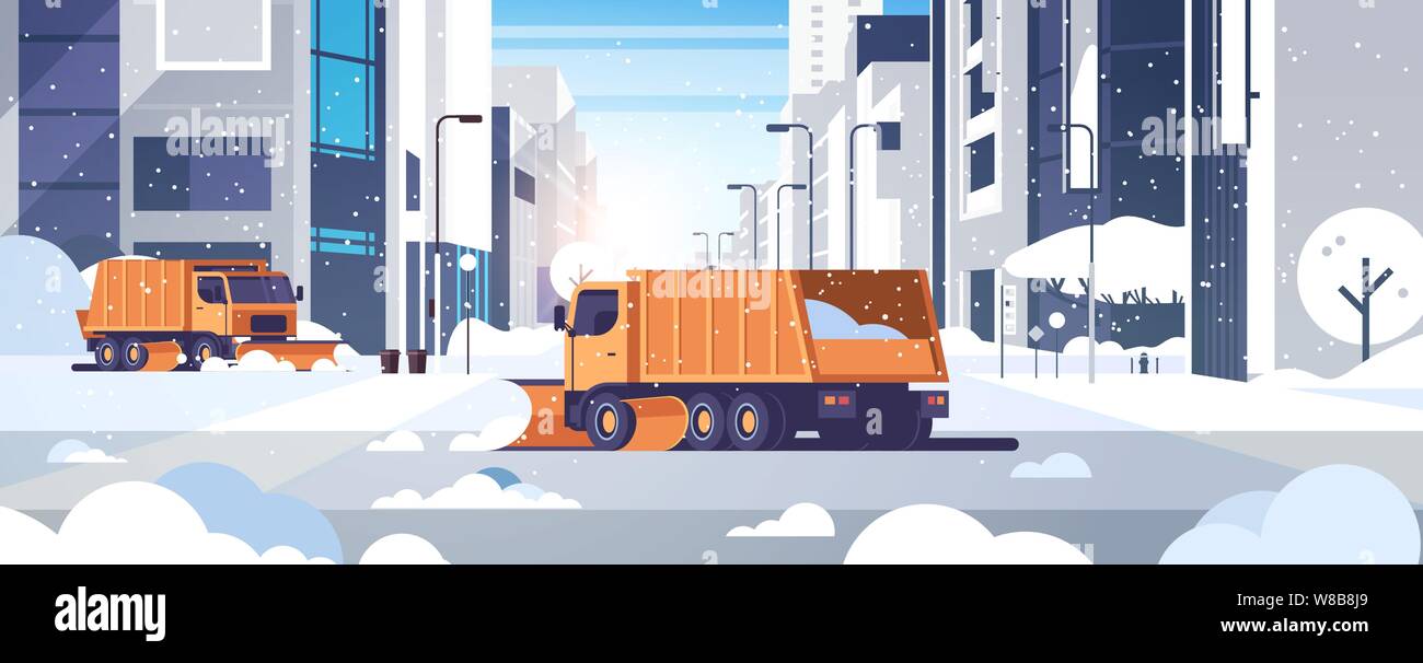 snow plow trucks cleaning road urban downtown street with skyscrapers