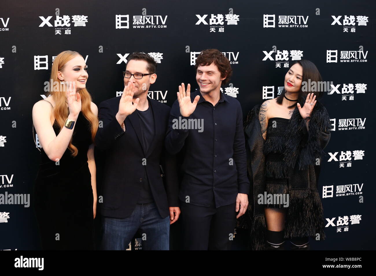 (From left) English actress Sophie Turner, American director Bryan Singer, actor Evan Peters and Chinese singer Tan Weiwei arrive for a premiere event Stock Photo