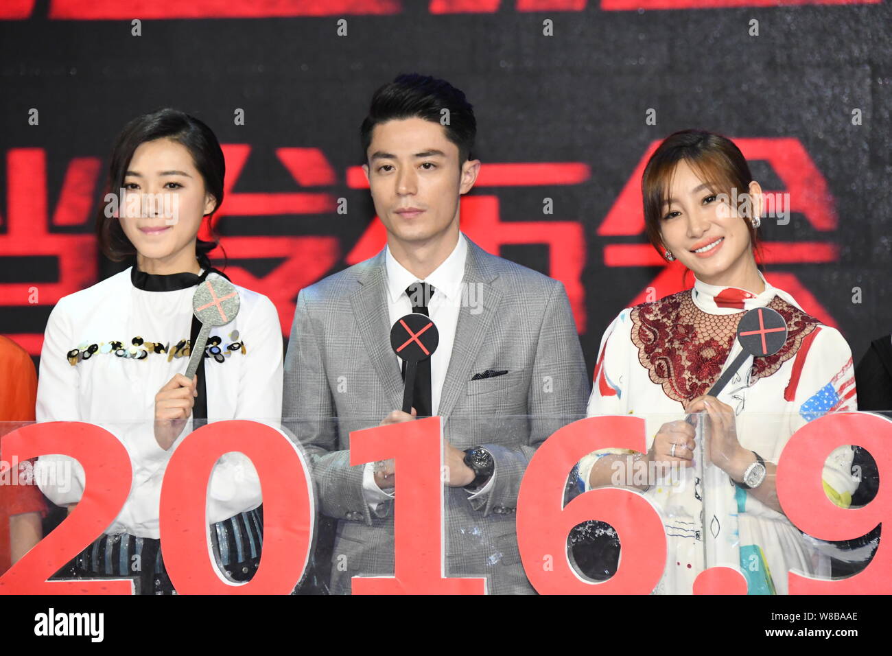 From left) Chinese actress Wan Qian, Taiwanese actor Wallace Huo and  Chinese actress Qin Hailu pose at a press conference for their movie "Hide  and S Stock Photo - Alamy