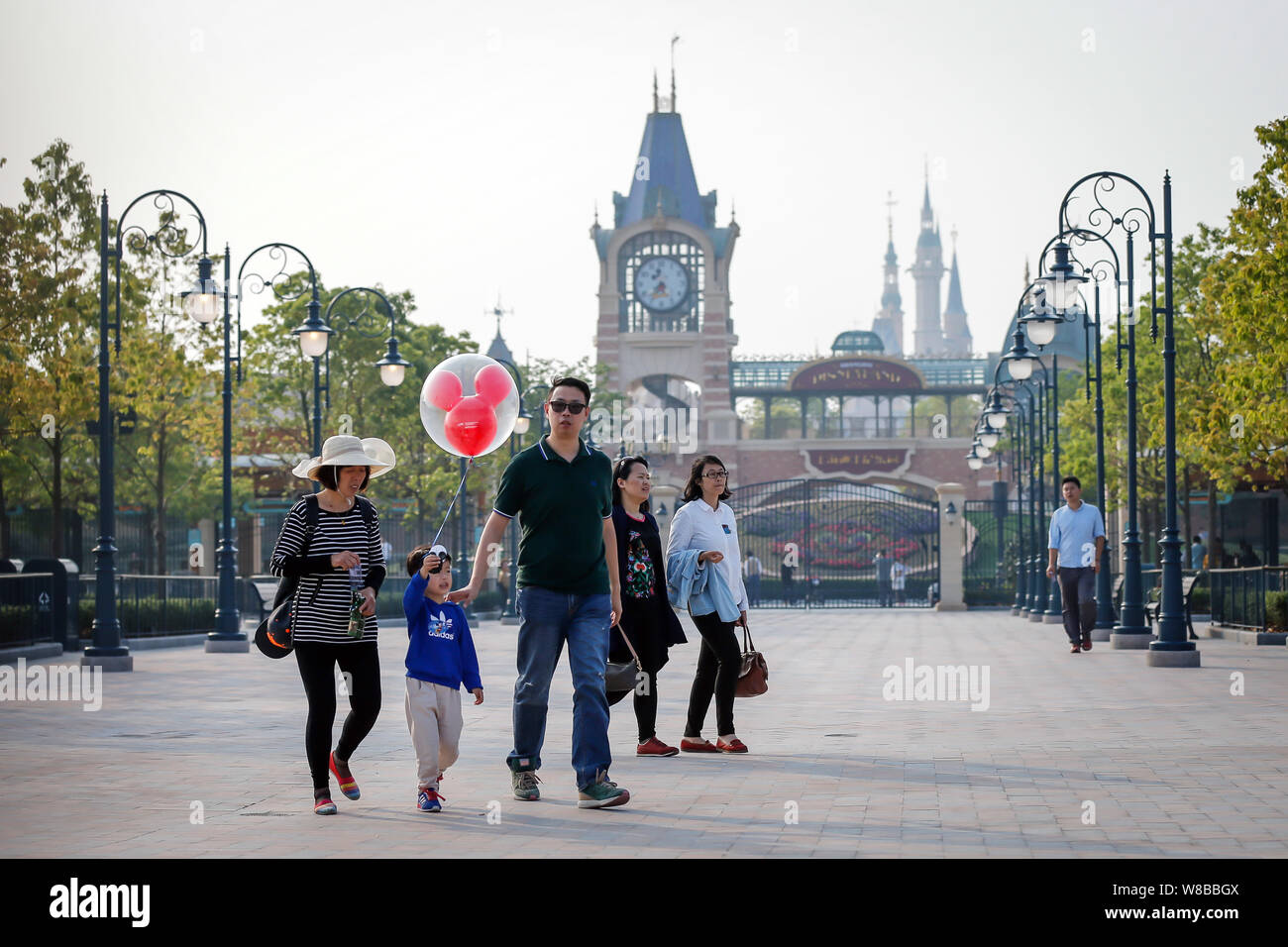 A Young Boy Holds Up A Mickey Mouse Balloon As He And His Family Exit From The Shanghai Disneyland At The Shanghai Disney Resort In Pudong Shanghai Stock Photo Alamy