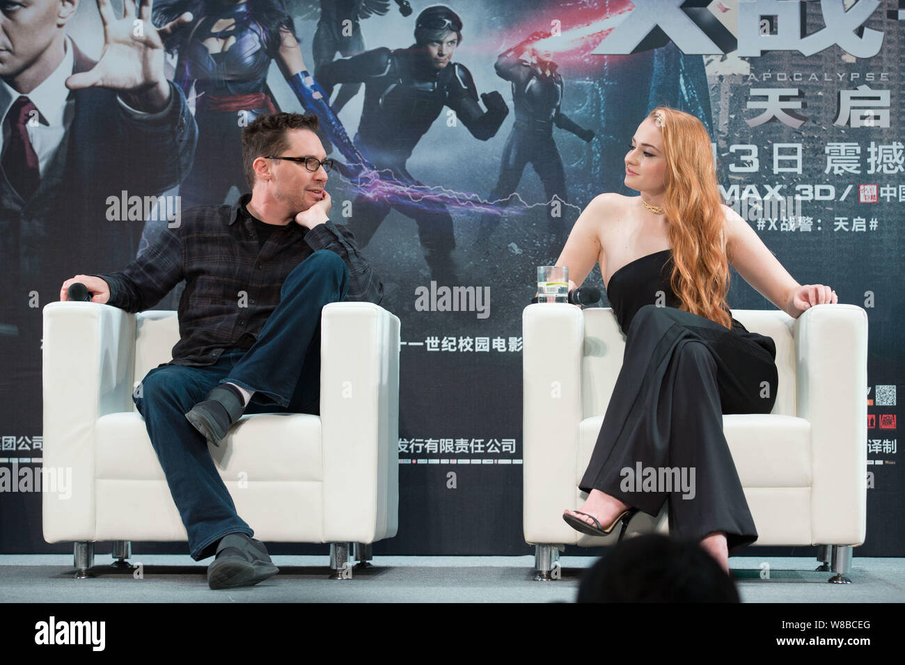 English actress Sophie Turner, right, and American director Bryan Singer attend a promotional event for their movie 'X-Men: Apocalypse' at Tsinghua Un Stock Photo