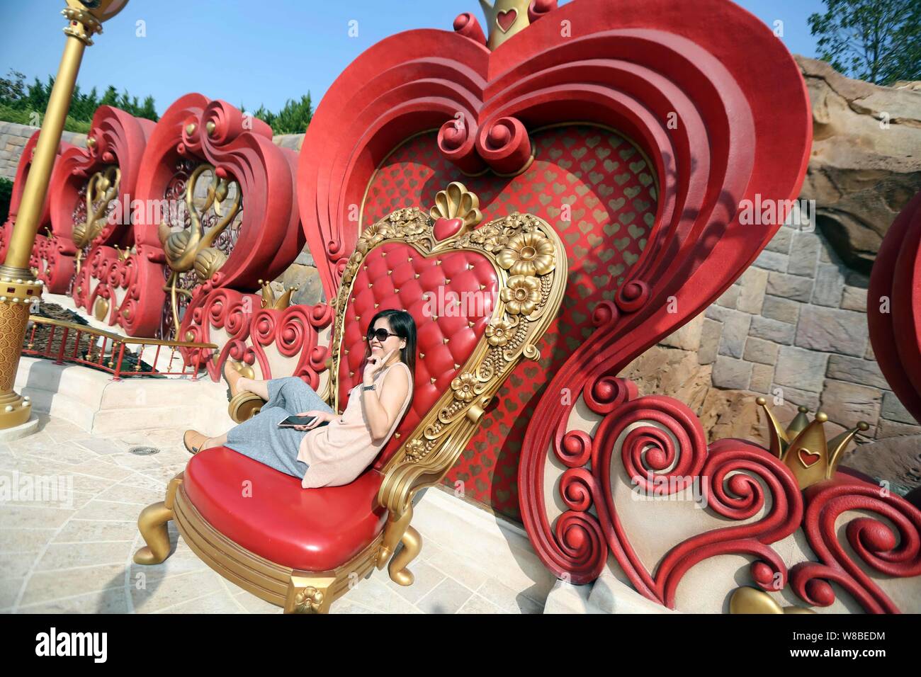 A Tourist Poses For Photos With Installations From The Movie Alice In Wonderland In The Shanghai Disneyland At The Shanghai Disney Resort In Pudong Stock Photo Alamy A Tourist Poses For Photos With Installations From The Movie Alice In Wonderland In The Shanghai Disneyland At The Shanghai Disney Resort In Pudong Stock Photo Alamy