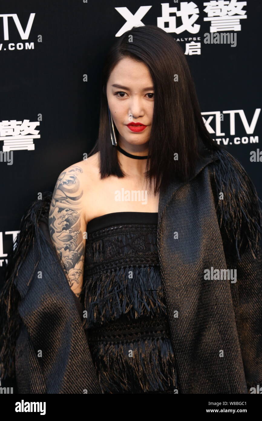 Chinese singer Tan Weiwei arrives for a premiere event of