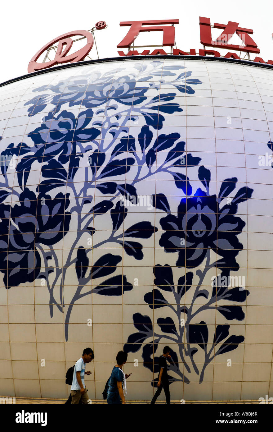 People walk past the Wanda Mall at the Nanchang Wanda Cultural Tourism ...