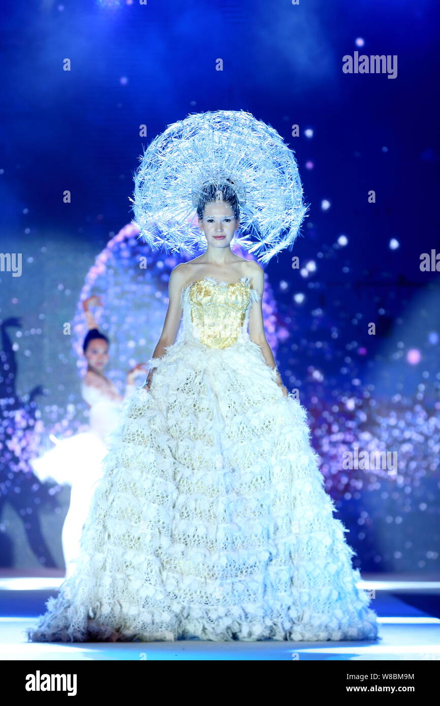 A model displays a new creation at a fashion show during the 2016 China Hairdressing Hair Fashion Awards in Shanghai, China, 20 April 2016. Stock Photo