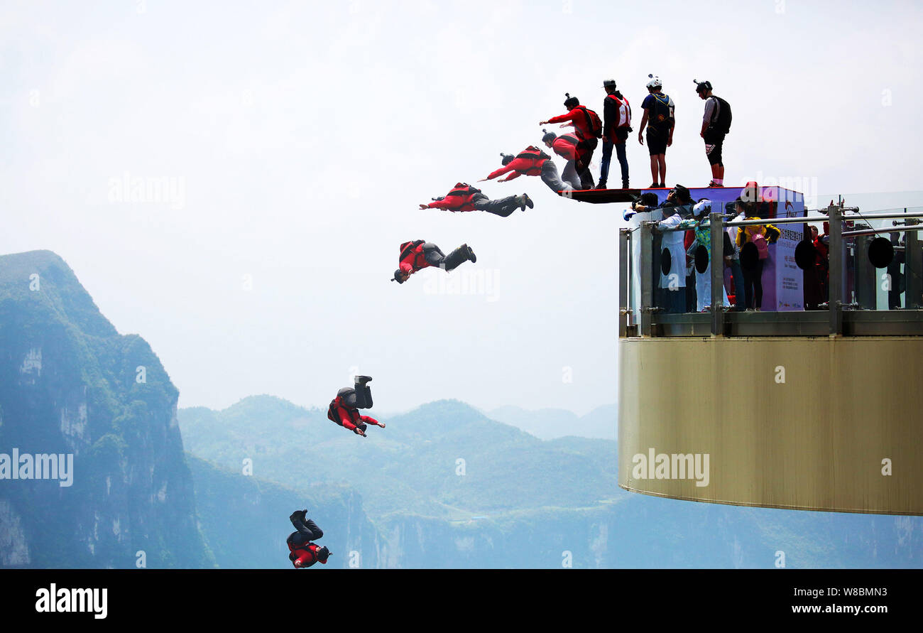 Contestants jump off the glass cantilever bridge on the cliff during the 2016 World Low-Altitude Parachute Jump contest in Longgang scenic area in Yun Stock Photo