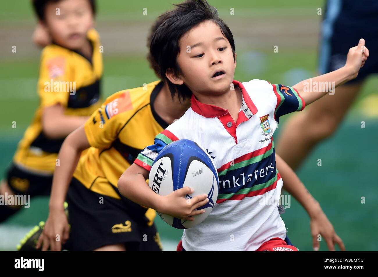 Young kids compete in a rugby game during the Hong Kong Sevens 2016 in Hong Kong, China, 8 April 2016. Stock Photo